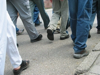 A close-up of people walking on the street Description automatically generated