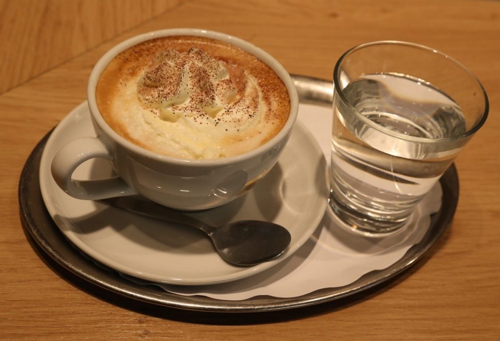 A cup of coffee and a glass of water AI-generated content may be incorrect.