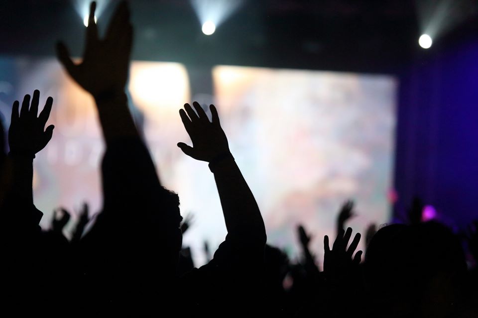 A group of people raising their hands AI-generated content may be incorrect.