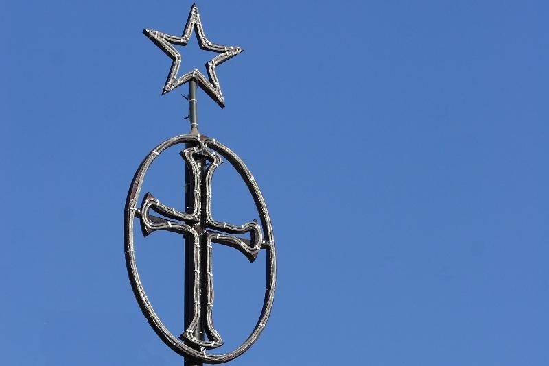 a-cross-and-star-on-top-of-a-pole-ai-generated-co A cross and star on top of a pole AI-generated content may be incorrect.