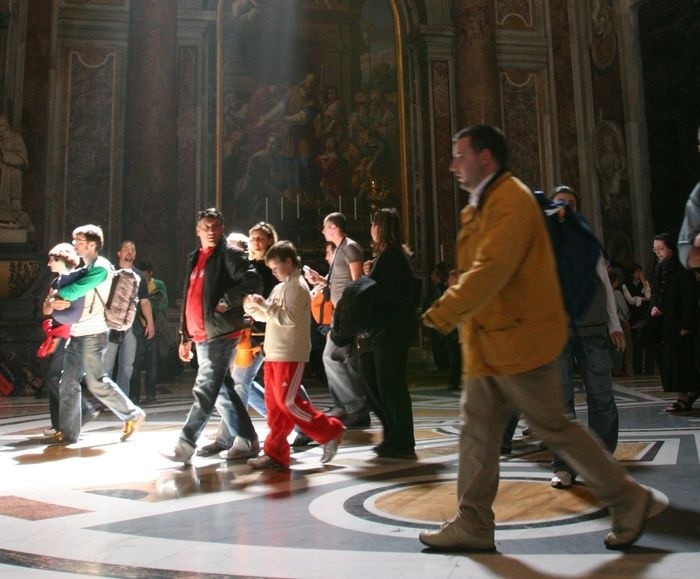 A group of people walking in a large room AI-generated content may be incorrect.