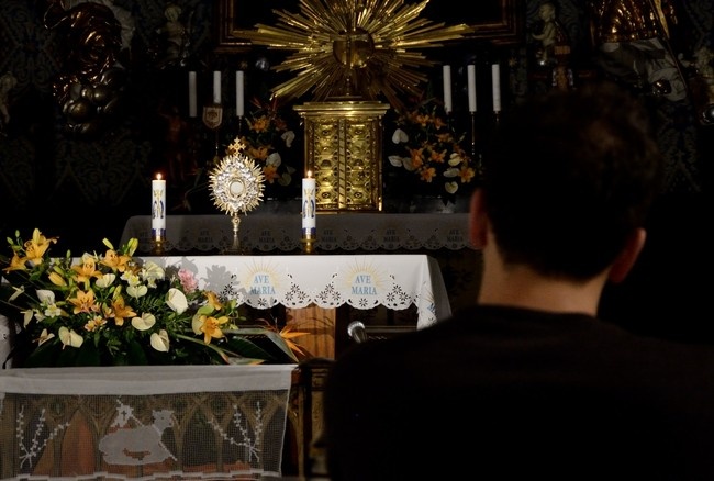 A person sitting in front of a table with flowers AI-generated content may be incorrect.