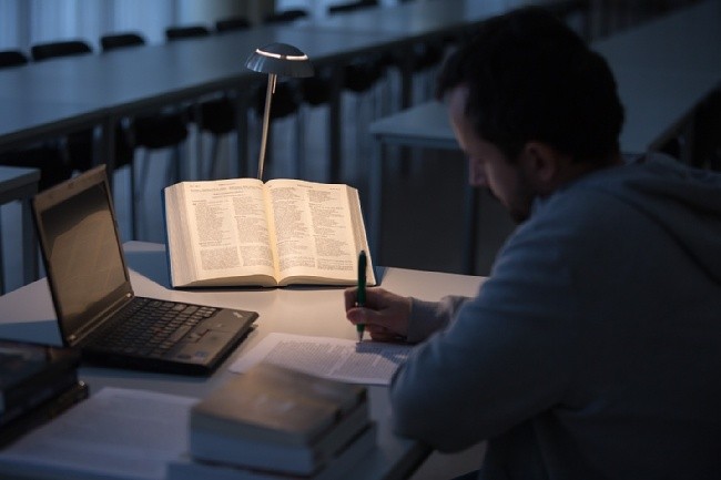 A person studying at a desk AI-generated content may be incorrect.