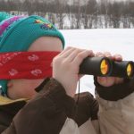 A child looking through binoculars AI-generated content may be incorrect.