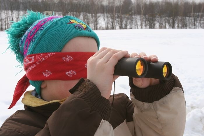 A child looking through binoculars AI-generated content may be incorrect.