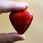 A person holding a heart AI-generated content may be incorrect.