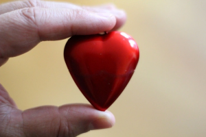 A person holding a heart AI-generated content may be incorrect.