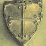 A stone shield with a cross AI-generated content may be incorrect.