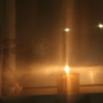 A candle in a window AI-generated content may be incorrect.
