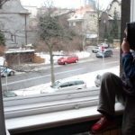 A child looking out a window AI-generated content may be incorrect.