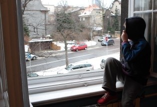 A child looking out a window AI-generated content may be incorrect.