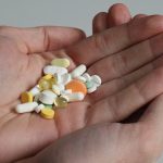 A handful of pills in a palm of your hand AI-generated content may be incorrect.