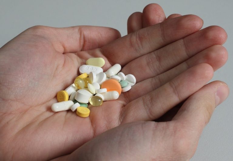 A handful of pills in a palm of your hand AI-generated content may be incorrect.