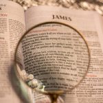 Reading the bible with magnifying glass