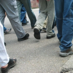 A close-up of people walking on the street Description automatically generated