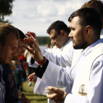 A group of men in white robes Description automatically generated